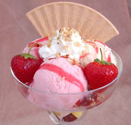 sundae with strawberry ice cream and fresh strawberries